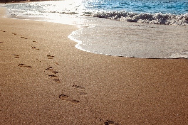 Footprints - sandy beach - sea